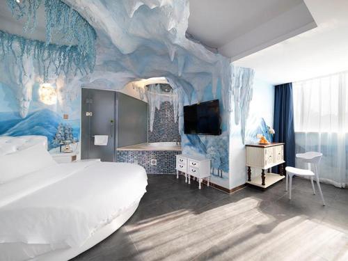 a bedroom with a large bed and a blue wall at Vienna Hotel Shenzhen Exibition Center in Shenzhen