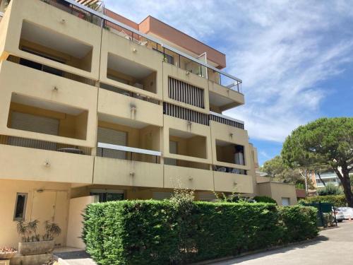 an apartment building with bushes in front of it at Studio Paradise entre mer et pins in Saint-Raphaël