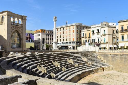 a large amphitheater in a city with buildings at Abalto Suites & Rooms in Lecce