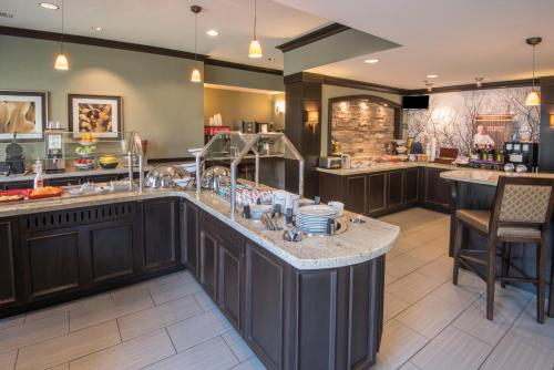 a large kitchen with a large island in the middle at Staybridge Suites Columbus-Airport, an IHG Hotel in Columbus