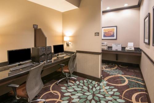 a hotel room with two desks and two computers at Staybridge Suites Columbus-Airport by IHG in Columbus
