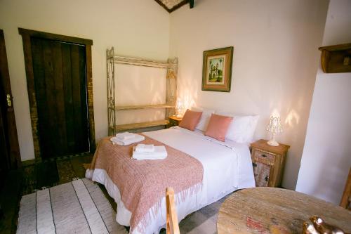 a bedroom with a large bed and a window at Pouso do Bichinho 1 in Bichinho