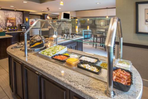 a buffet line with many different food items on it at Staybridge Suites Columbus-Airport by IHG in Columbus
