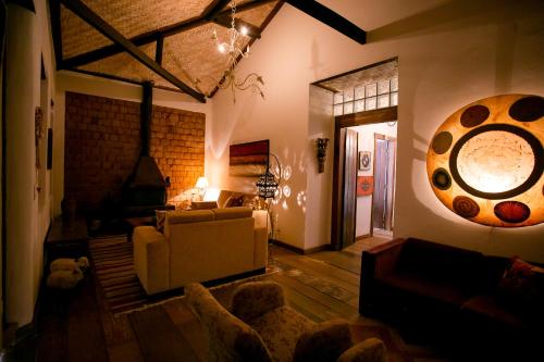a living room with a couch and a table at Pouso do Bichinho 1 in Bichinho