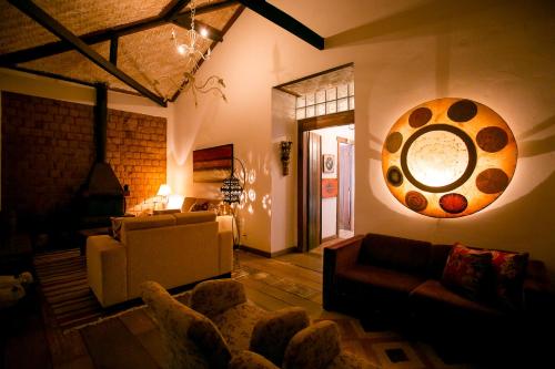 a living room with a couch and a painting on the wall at Pouso do Bichinho 1 in Bichinho