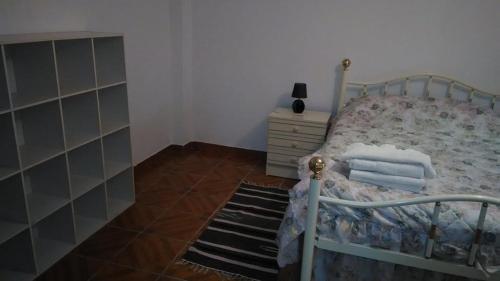 a bedroom with a bed with a metal frame at Casa das Lezírias in Unhais da Serra