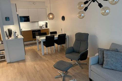 a living room with a couch and a table and chairs at Tampere City view near Nokia Arena AC in Tampere