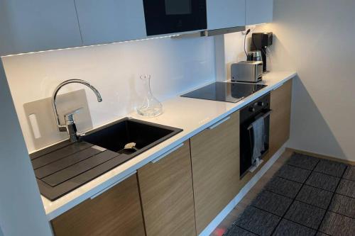 a kitchen with a sink and a counter top at Tampere City view near Nokia Arena AC in Tampere