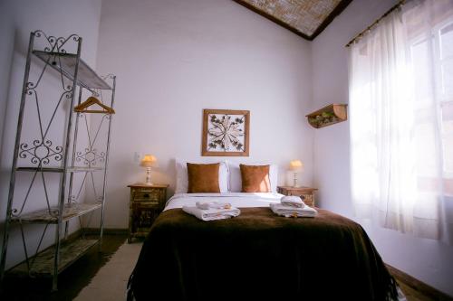 a bedroom with a bed with two towels on it at Pouso do Bichinho 1 in Bichinho