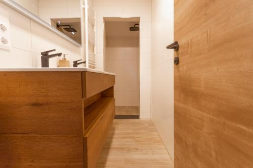 a bathroom with a sink and a wooden door at Haus Hoen in Untertweng