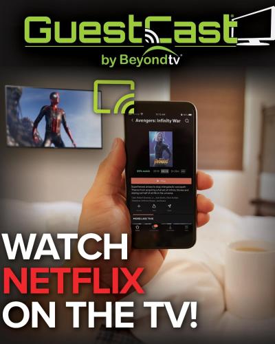 a hand holding a cell phone in front of a tv at Executive Inn and Suites Wichita Falls in Wichita Falls