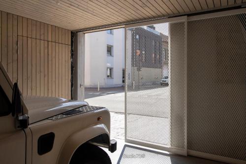 a truck parked next to a building with a gate at Studio73, Guesthouse met sauna in Kortrijk