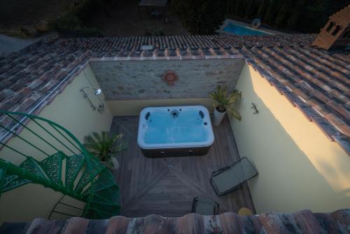 a hot tub on the deck of a house at Il Mulino in Civitella deʼ Conti