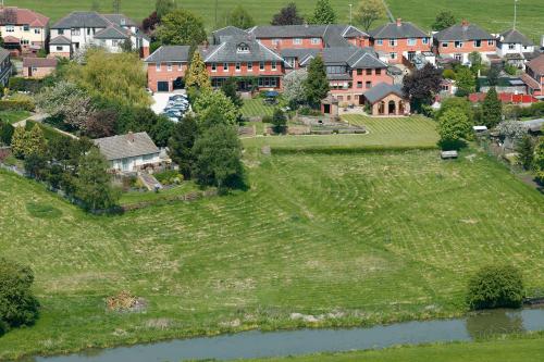 an aerial view of a village with a river and houses at Best Western Sysonby Knoll Hotel in Melton Mowbray