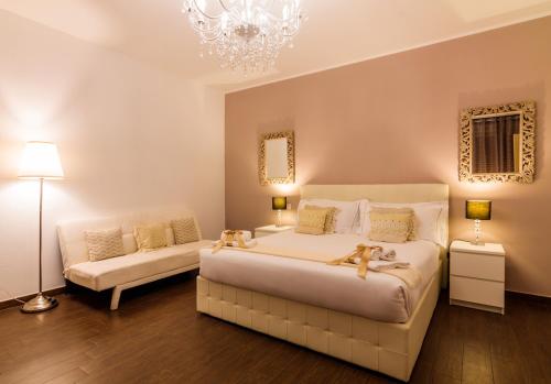En eller flere senge i et værelse på Arcobaleno Suites