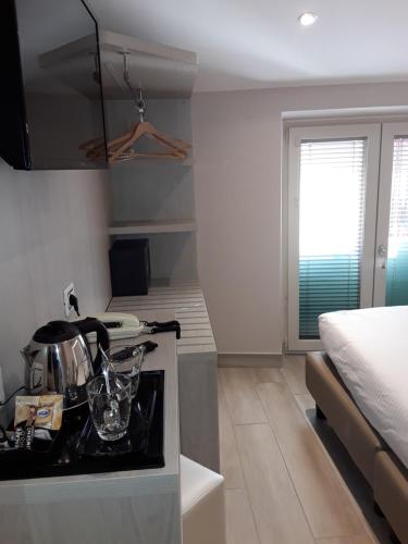 a kitchen with a stove top oven next to a bed at Hotel Danieli La Castellana lago di Garda in Brenzone sul Garda