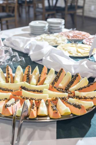 a table topped with plates of food on a table at Vila Dom Bosco in Campos do Jordão