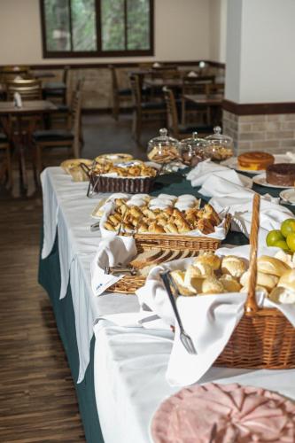 a long table with food on top at Vila Dom Bosco in Campos do Jordão