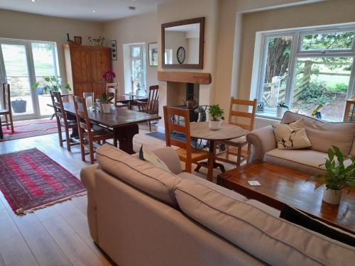a living room with a couch and a table at Sunny Nest in Bourton on the Water