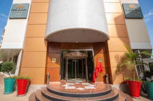 a building with a revolving door in front of it at Hotel Atlantic Agdal in Rabat