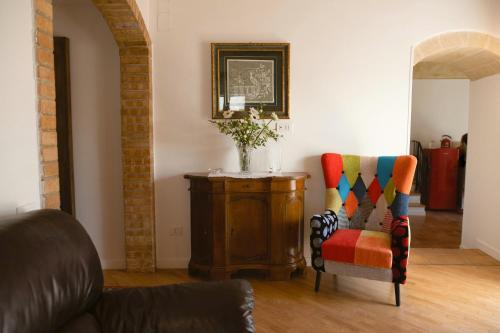 a living room with a chair and a table at La Casa di Ele in Matera