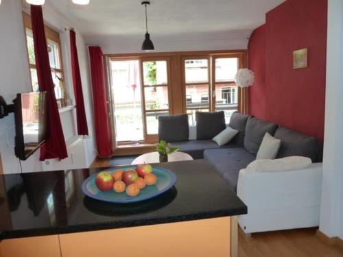a living room with a bowl of fruit on a counter at Ferienwohnung - Mittendrin - in Wangen im Allgäu