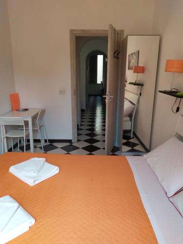 
a room with a bed, a table and a refrigerator at Room CasaVostrA in Rome

