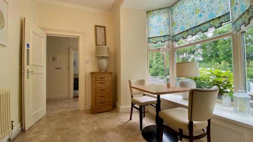 a dining room with a table and a window at Hafan Artro in Llanbedr