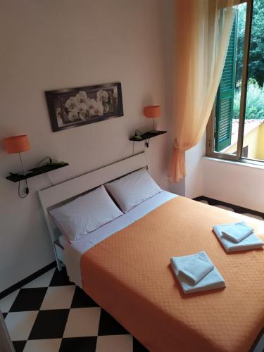 a bedroom with a bed with two towels on it at Room CasaVostrA in Rome