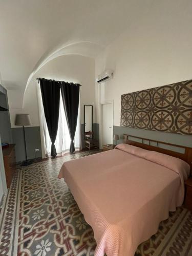 a bedroom with a bed and a large window at L'Armonia in Gaeta