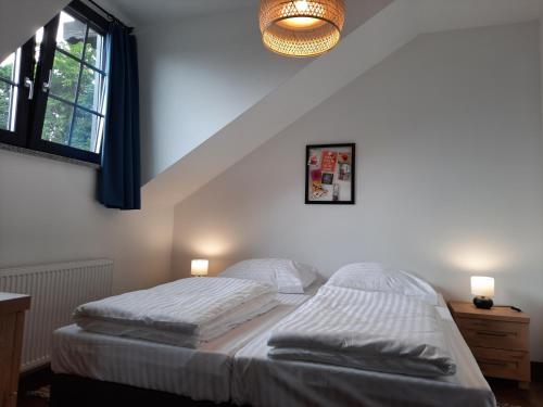 a bedroom with a bed with two pillows on it at Apartament 515 in Szklarska Poręba