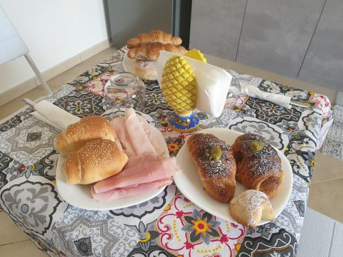 a table topped with plates of pastries and bread at Lo Scorcio Sullo Stagnone in Marsala