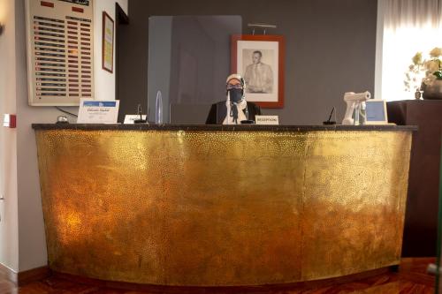 a gold counter with two figurines on top of it at Hotel Atlantic Agdal in Rabat