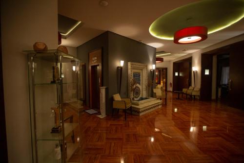 a room with a hallway with wooden floors and a green ceiling at Hotel Atlantic Agdal in Rabat