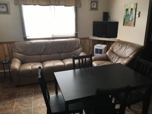 a living room with a couch and a table at The Maples Cottages in Port Elgin in Port Elgin