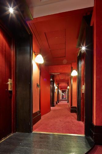 an empty corridor in a building with red walls at Grand Hotel de l'Opera - BW Premier Collection in Toulouse