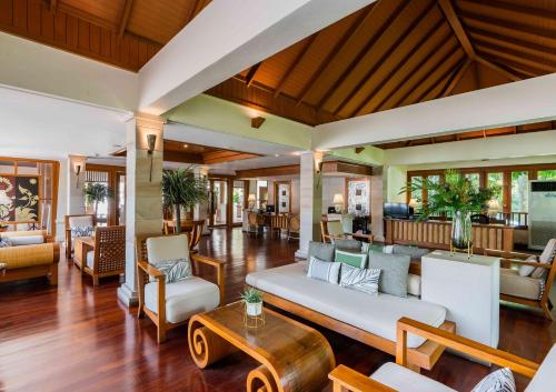 a living room with a couch and chairs at Naithonburi Beach Resort - SHA Extra Plus in Nai Thon Beach