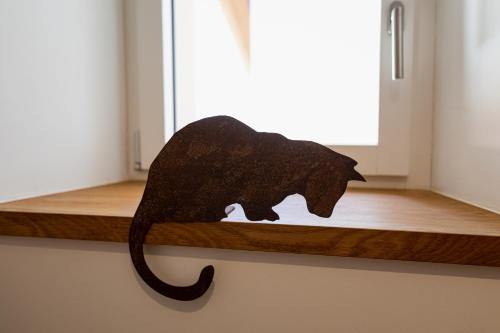 a statue of an elephant sitting on a shelf at La Ferme de la Praz - Rooms with a View in La Praz