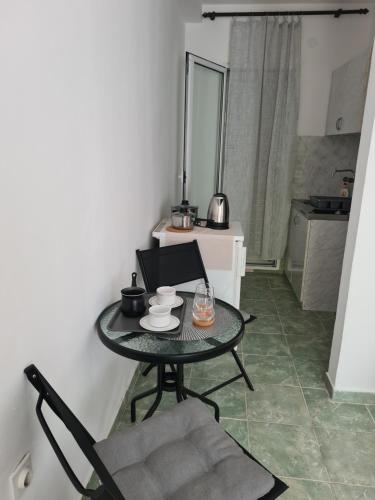 a table in a room with a chair and a mirror at Apartman Rosemary in Sveti Stefan