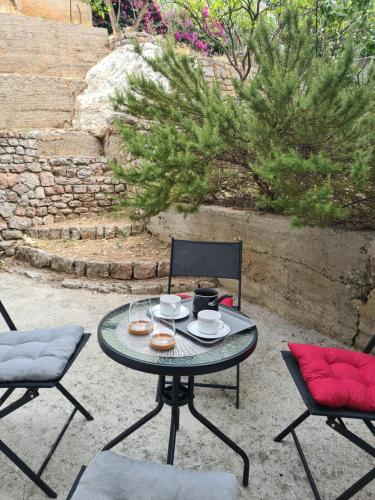 a table and chairs on a patio with food on it at Apartman Rosemary in Sveti Stefan