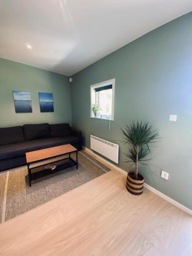 a living room with a couch and a table at Enkegården Gårdshotell in Ängelholm