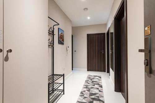 a hallway with a black and white rug at Work-Ready Apartment - Reliable and Relaxing - Apartment 3 in Gillingham