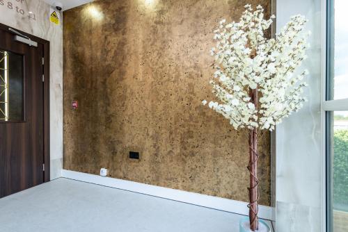 a plant in a vase next to a wall at Perfect for Work Stays - Apartment 4 in Gillingham