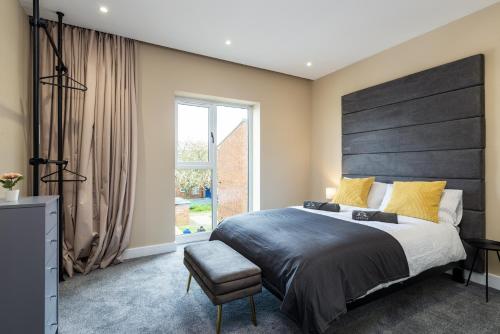 a bedroom with a large bed and a window at Perfect for Work Stays - Apartment 4 in Gillingham