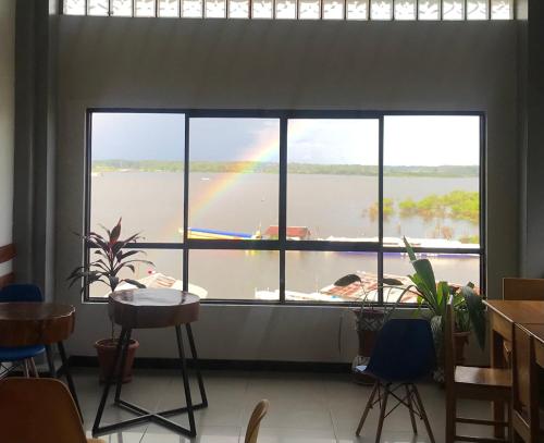 a rainbow is seen through a window in a room at Amazon Dream Hostel with AC and Starlink in Iquitos