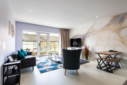 a living room with a couch and a table at NeuConnect contractor base near Grain - Apartment 5 in Gillingham