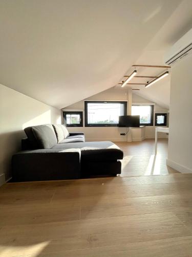 a bedroom with a bed and a couch in a room at Agora LX Studios & Suites in Thessaloniki