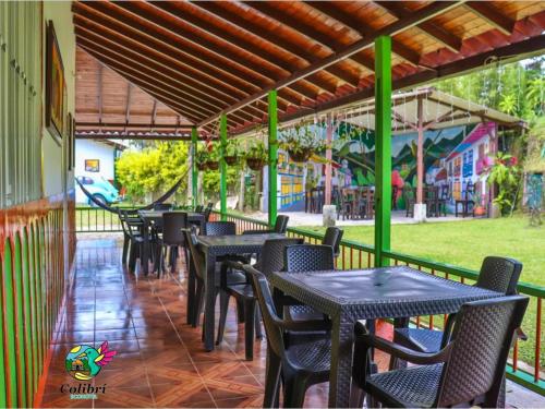 a row of tables and chairs on a patio at EcoHotel Colibrí Salento in Luna Park