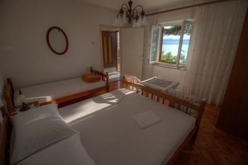 a bedroom with two beds and a window at Marijanka in Sveti Juraj