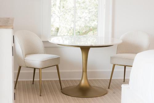 a glass table and two chairs in a room at Oyster Bay Boutique Hotel in Pensacola